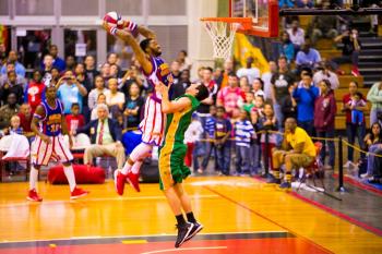 Harlem Globetrotters forward, Tydran ‘Crash’ Beaty, throws down the fanatic game winning dunk over a Washington Generals defender on Dec. 9 at The Foster Field House on Camp Foster