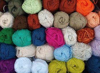 A stack of skeins of yarn in various colors.